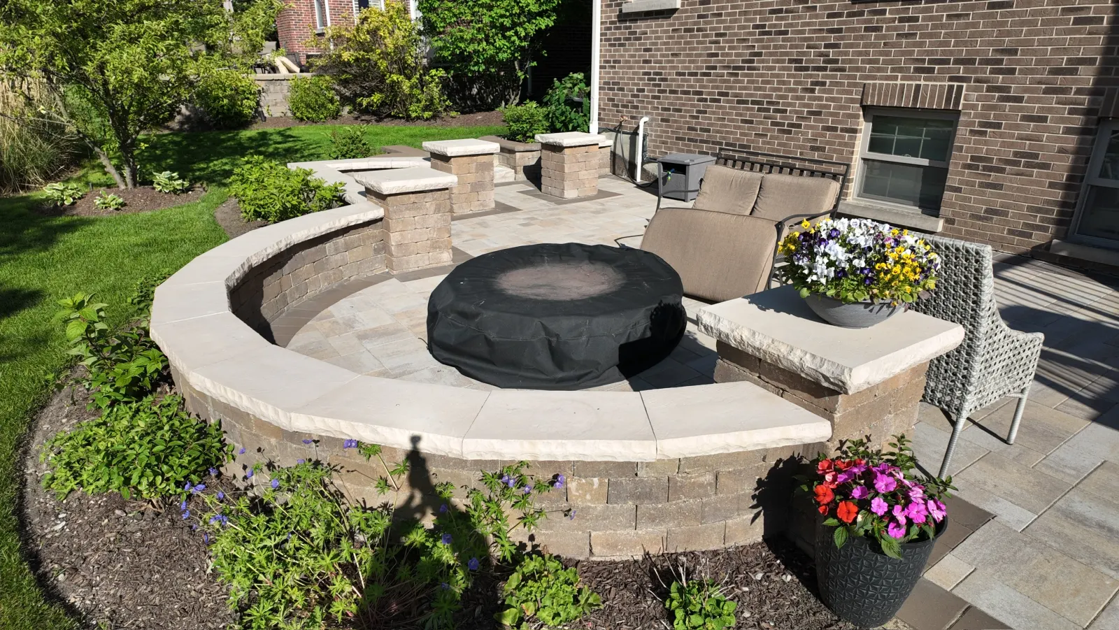Curved Unilock paver patio with built-in fire pit and seating wall — Winfield, IL